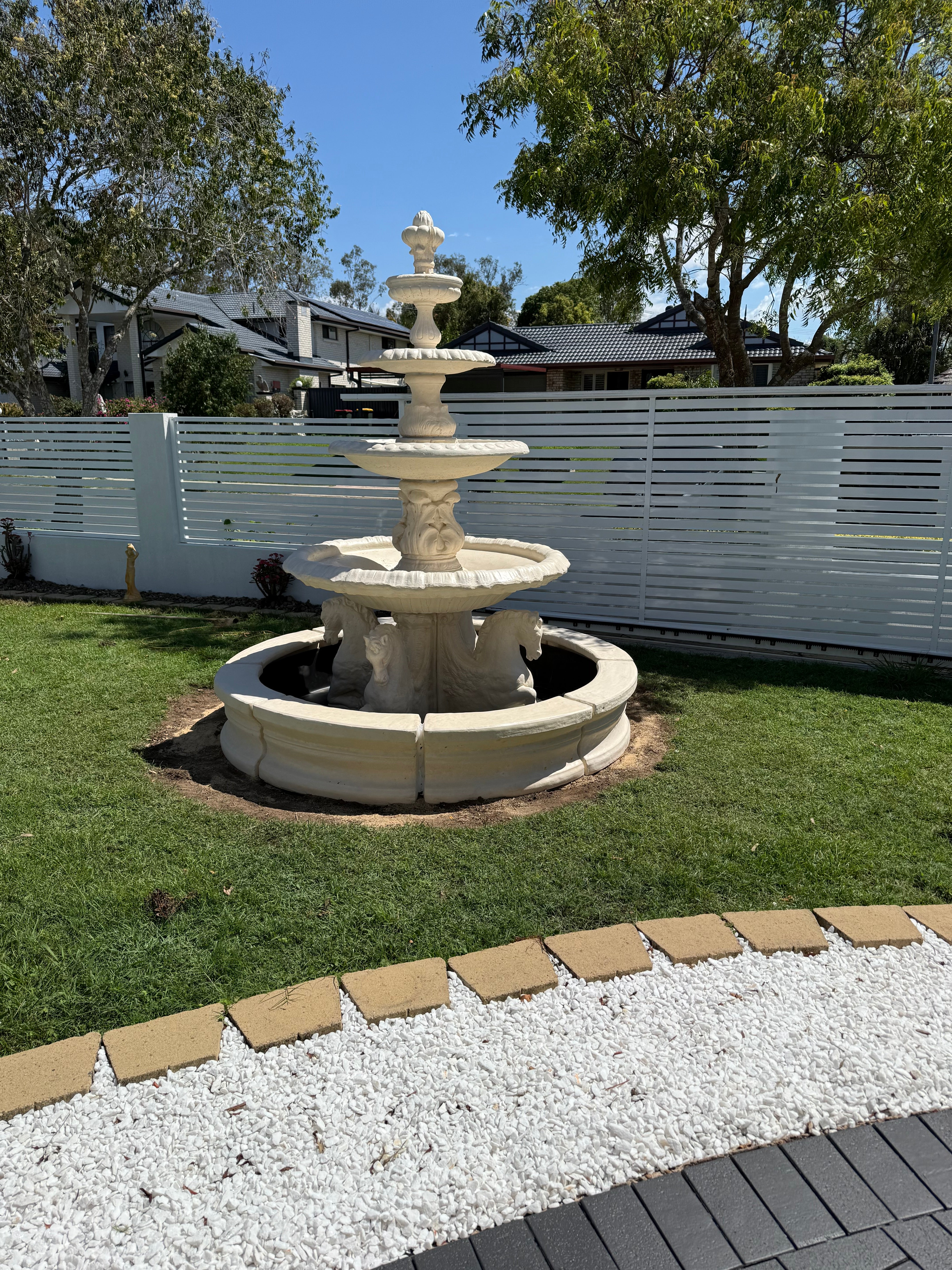 4 tier quarter horse fountain with traditional acorn in traditional pond surround