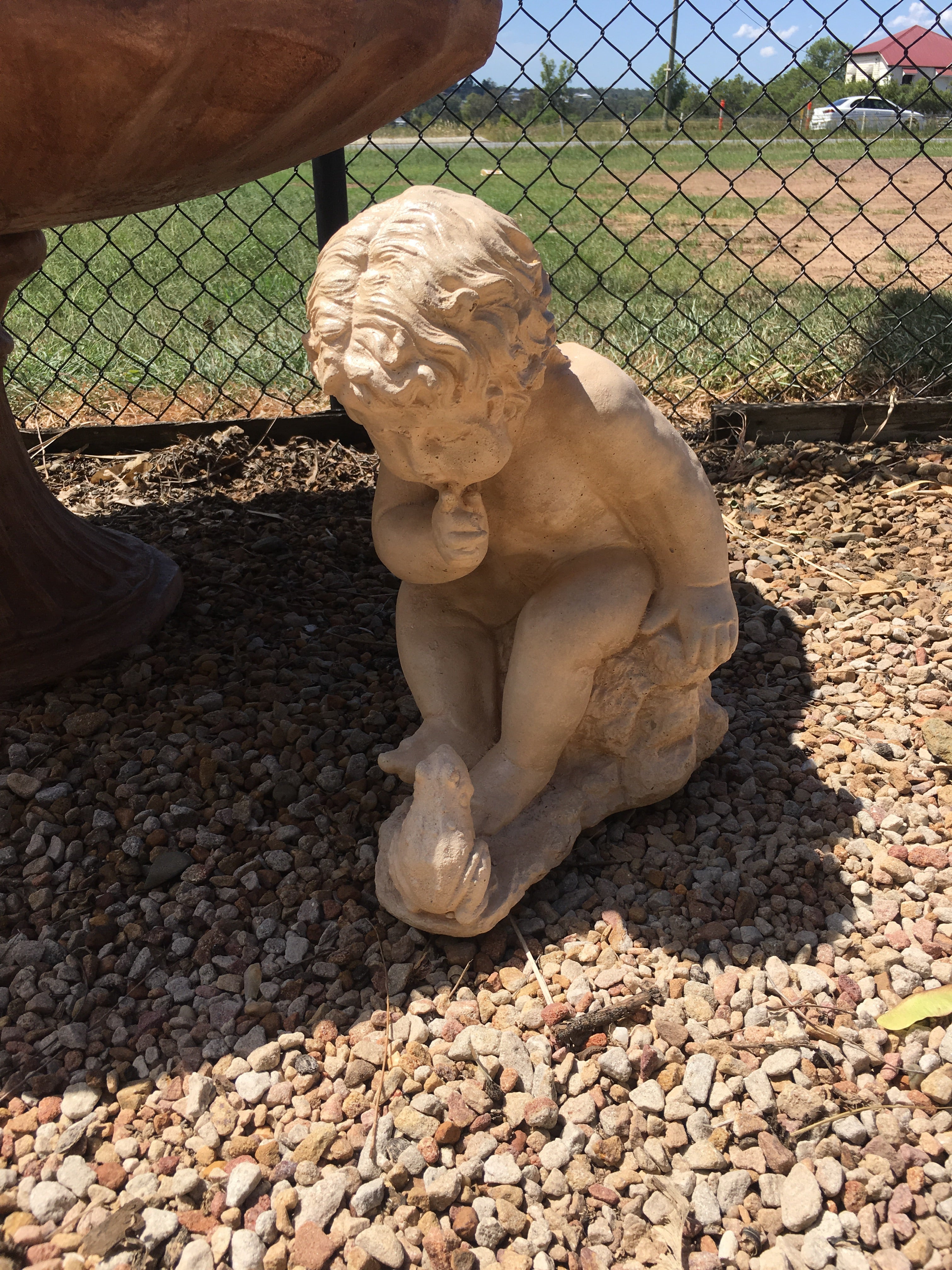 Boy with frog statue
