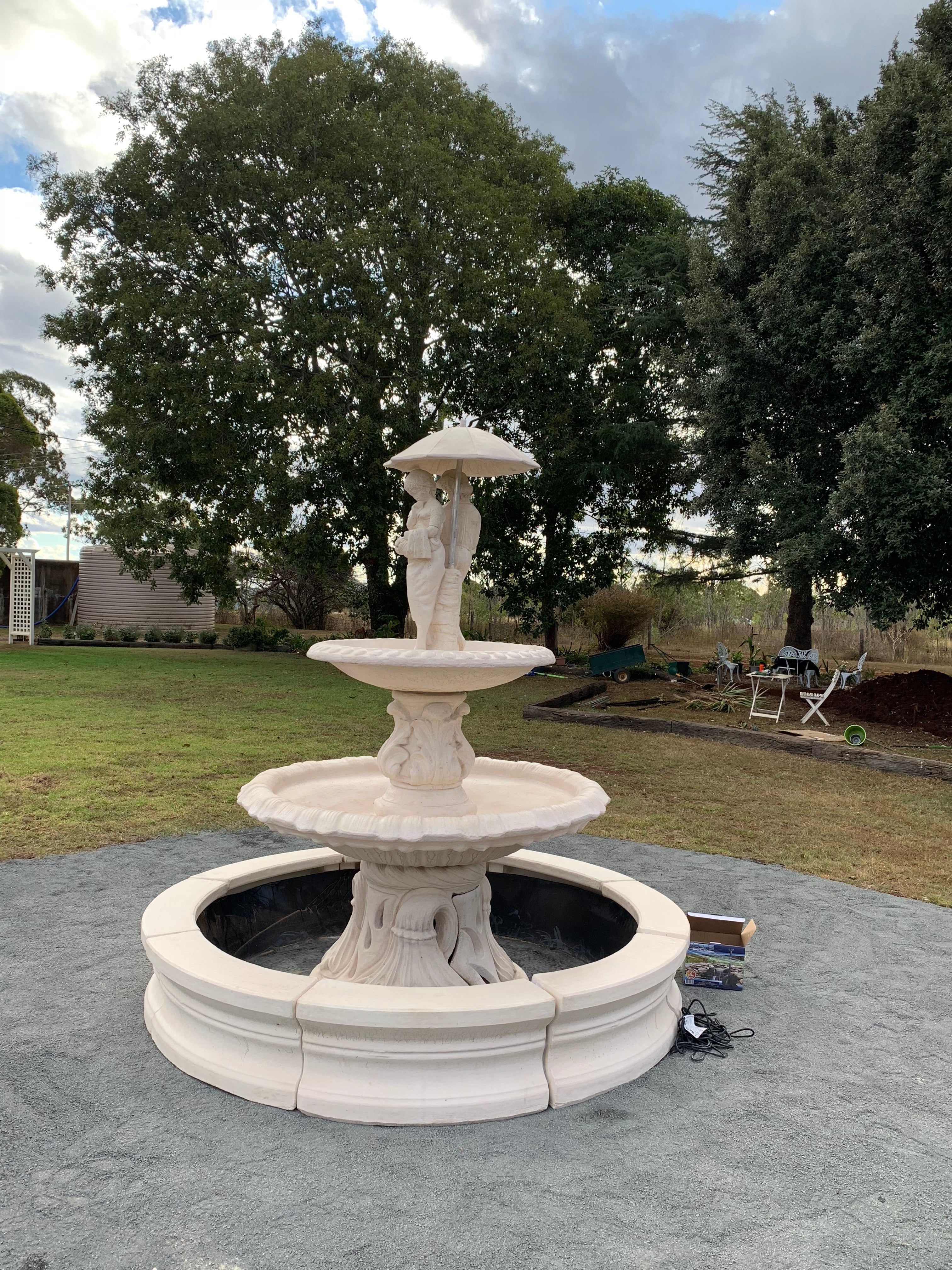 2 tier Italian fountain with spring time and traditional pond surround