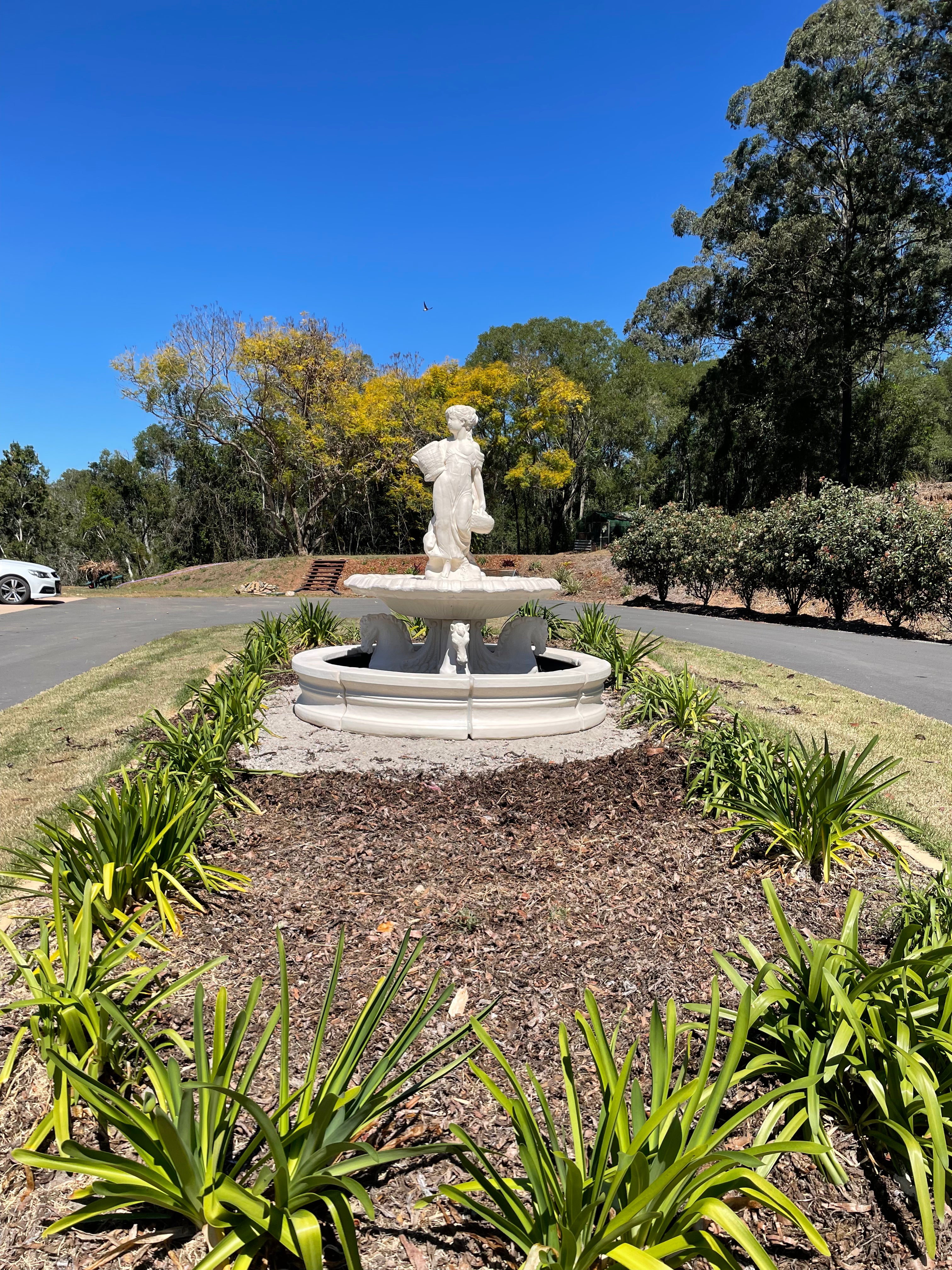 Quarter horse fountain with basket lady and traditional pond surround