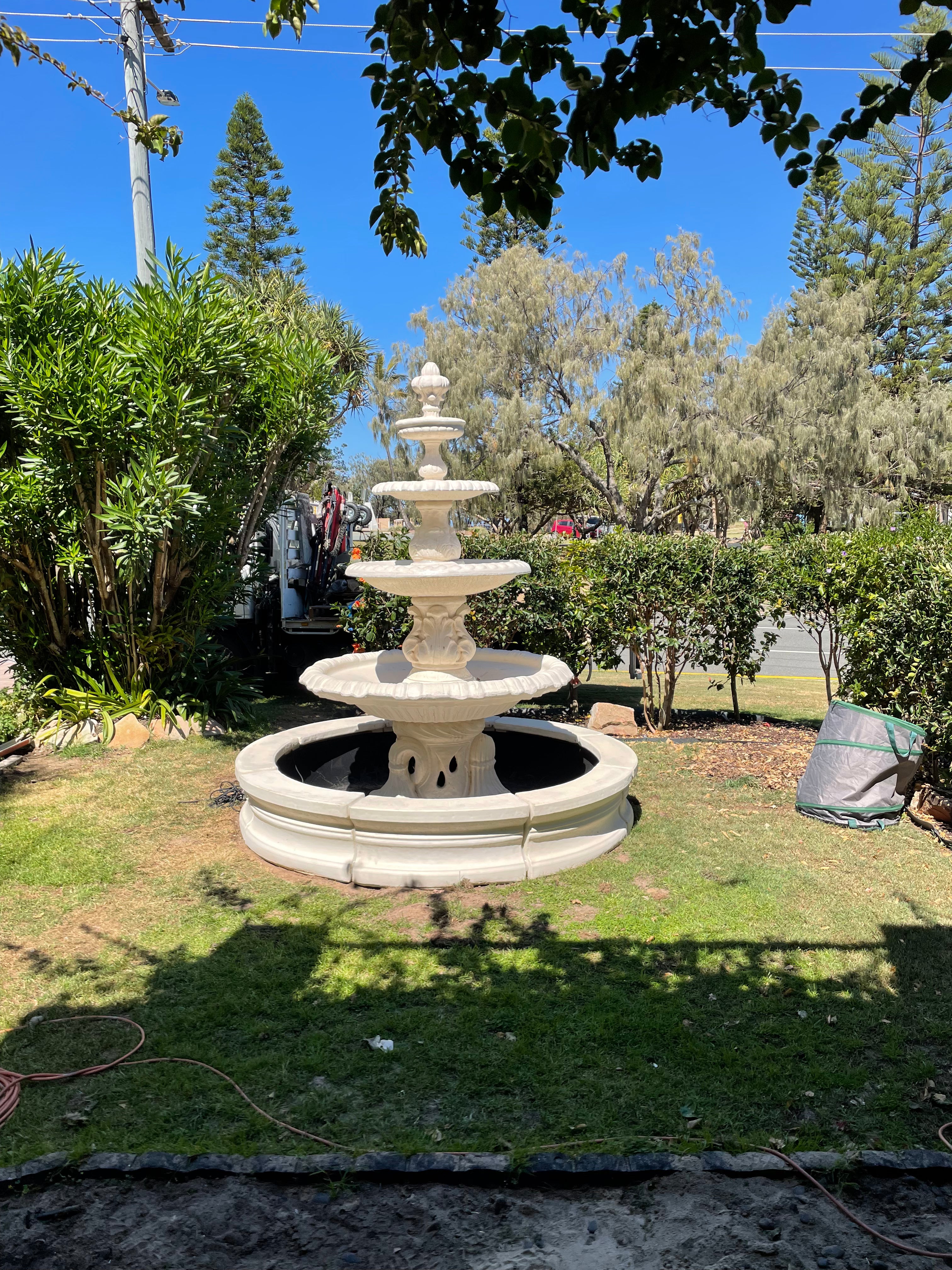 4 tier Italian fountain with traditional acorn and traditional pond surround