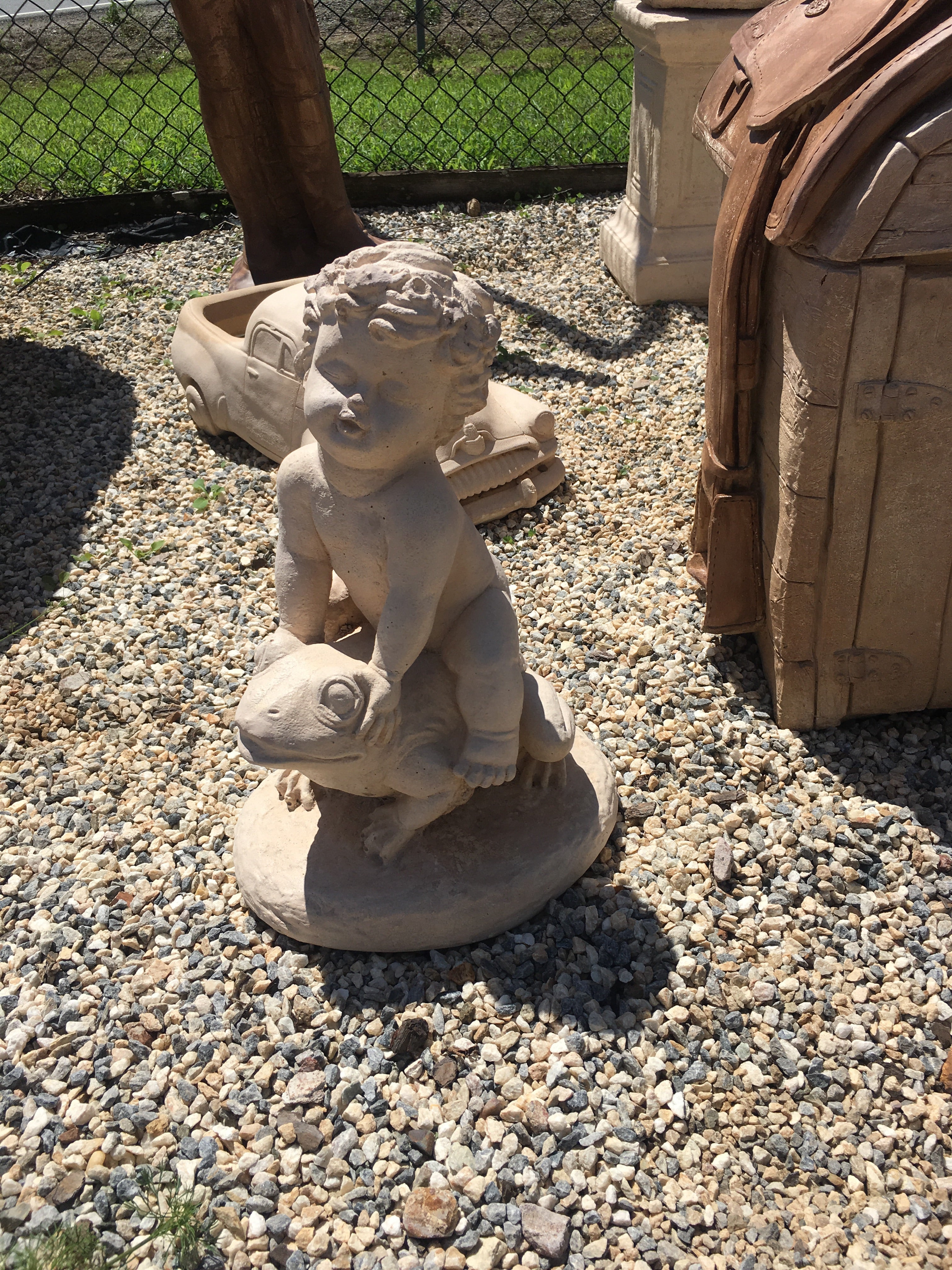 Boy on frog statue